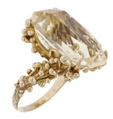 A citrine dress ring, circa 1970, the cut-cornered scissor-cut citrine within a sinuous mount of beaded tendrils,...