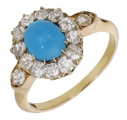A turquoise and diamond cluster ring, circa 1900, the turquoise cabochon within a surround of old brilliant-cut...