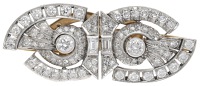 A diamond double clip brooch, circa 1940, the geometric scrolls set with old brilliant, single and baguette-cut...
