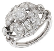 A diamond dress ring, the bombé flowerhead of openwork design, set throughout with brilliant and single-cut...