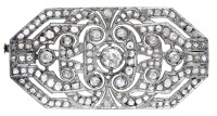 An Art Deco diamond brooch, the pierced plaque with canted corners and set throughout with old brilliant and...