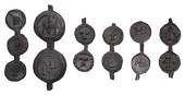 Strips of conjoined tokens, as made (6), five pairs and a trio, each set with the same design repeated, a single...