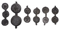 Strips of conjoined tokens, as made (6), five pairs and a trio, each set with the same design repeated, a single...
