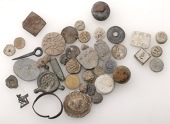 Miscellaneous lead artefacts (40), including bosses, badges, buttons, a sundial ring, two knobs/grapeshot, gaming...