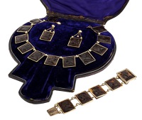 A 19th century tortoiseshell cameo necklace, bracelet and ear pendant suite, depicting various portraits in profile,...