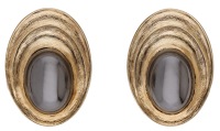 A pair of hematite ear clips, the hematite cabochons within a reeded surround with textured finish, maker’s mark...