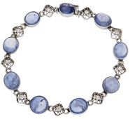 An early 20th century sapphire and diamond bracelet, composed of alternating collet-set sapphire cabochons and...
