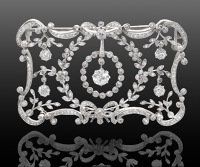 An early 20th century diamond jewel, the slightly bowed rectangular panel of floral garland design, set throughout...