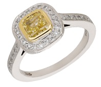 A Fancy coloured diamond ring, set with a cut-cornered square-shaped diamond of yellow tint, weighing 0.66 carat,...
