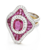 A ruby and diamond dress ring, circa 1980, the lozenge-shaped plaque set with an oval-cut ruby, weighing...