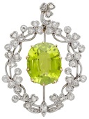 An early 20th century peridot and diamond pendant, the cushion-shaped peridot encircled by rose and old-cut diamond...