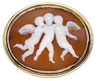 A 19th century shell cameo brooch, carved to depict three putti embracing, within a reeded gold mount, width 41mm. 	...