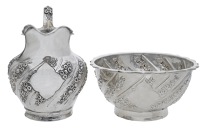 A Victorian silver small sugar basin and cream jug, repoussé decorated with wrythen bands of blossom, by Charles...