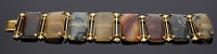 A Georgian agate bracelet, the eight rectangular panels of varicoloured agates each claw-set, the baton-links...