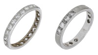 Two diamond eternity rings, the first set throughout with old brilliant-cut diamonds, the second spaced by...