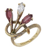An 18ct gold garnet and diamond ring, 1972, the entwined textured spray claw-set with marquise-cut garnets and a...