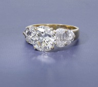 A diamond ring, the transitional-cut diamond, weighing 3.34 carats, between shoulders set with marquise and...