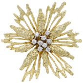 An 18ct gold and diamond brooch, 1972, the openwork starburst with textured decoration and a cluster of...