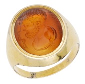 A carnelian intaglio ring, carved to depict Asclepius, the god of medicine, accompanied by his staff, mounted in...