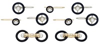 An Art Deco gentleman’s dress set, of knifewire target design, set with pearls within black enamel surrounds,...