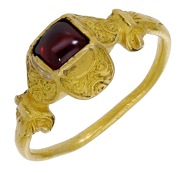 An early 17th century gold ring, probably Spanish, the raised square bezel with double lobed setting, the lower...