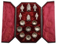 An Anglo-Indian silver large condiment set, comprising four octagonal and four circular salts, a pair of peppers,...
