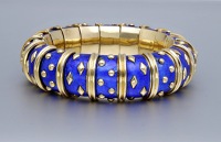 An enamel ‘Dot Lozenge’ bangle by Schlumberger, circa 1960, the articulated strap of blue paillonné enamel,...