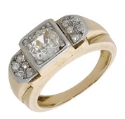 A diamond dress ring, circa 1940, of odeonesque design, set with an old brilliant-cut diamond between demi-lune...