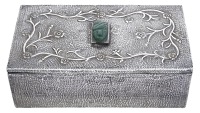A Mexican silver cigarette box, hand spot-hammered, the lid centered with a greenstone native mask and with applied...