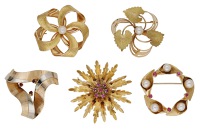 A collection of five brooches, comprising three cultured pearl brooches, a flowerhead brooch, and a bicolour...