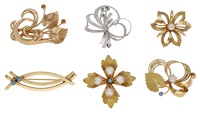 A collection of gem-set brooches, comprising three foliate spray brooches, two flowerhead brooches set with cultured...