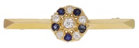 A sapphire and diamond bar brooch, set with circular-cut sapphires and old brilliant-cut diamonds, to a knife-edge...