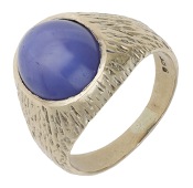 A star sapphire ring, circa 1970, the oval star sapphire cabochon, measuring approximately 11.7 x 9.8 x 5.2mm, to a...