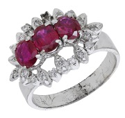 A ruby and diamond dress ring, set with four oval-cut rubies within a flowerhead surround set with single-cut...