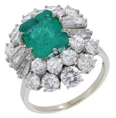 An emerald and diamond cluster ring, the step-cut emerald within a surround of brilliant and tapered baguette-cut...
