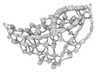 A diamond spray brooch, of openwork tiered design, set throughout with baguette and brilliant-cut diamonds, stamped...