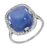 A Sri Lankan sapphire and diamond ring, circa 1920, the cushion-shaped sapphire cabochon within a surround of...
