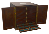 A polished dark wood coin cabinet, 36 x 36 x 36cm, comprising 24 trays double-pierced to hold a total of 1,453...