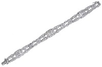 A mid 20th century diamond bracelet, of openwork geometric design, set throughout with brilliant, baguette and...