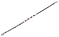 A ruby and diamond bracelet, set to the centre with circular-cut rubies and brilliant-cut diamonds, to a fancy...