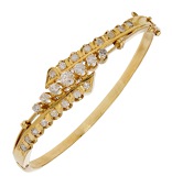 A diamond bangle, of crossover design, set to the front with brilliant and single-cut diamonds, total diamond weight...