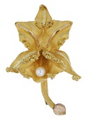 An orchid brooch, realistically modelled with matte ground and applied bicolour polished highlights, with cultured...