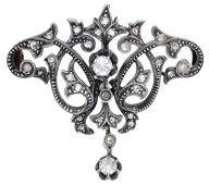 A late 19th century diamond brooch / pendant, of whiplash foliate design, set throughout with old brilliant and...