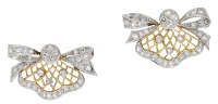 A pair of diamond brooches, of bicolour design, the wirework lattice fans surmounted by bows, set throughout with...