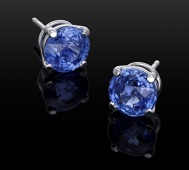 A pair of sapphire ear studs retailed by Theo Fennell, the circular mixed-cut sapphires in four claw settings,...
