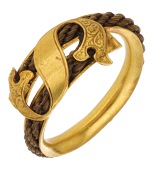 A mid 19th century hairwork mourning ring, the crossover gold band with a rope of plaited hairwork, with an applied...