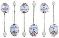 A matched set of six silver and enamelled coffee spoons, the backs decorated with foliage and ribbons on a wavy...