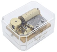 A table cylinder musical box by Reuge, in perspex case with chamfered angles, playing ‘Pachelbel’s Canon’,...