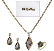A suite of andalusite jewellery, the ring by Garrard & Co., and set with a step-cut andalusite between shoulders of...