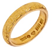 An engraved band, 1967, with floral decoration throughout, Swedish assay mark for 18ct gold, ring size P. 	 £500-£700